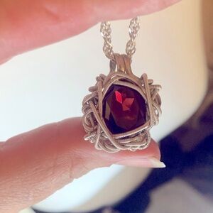 Large faceted garnet silver pendant is overflowing